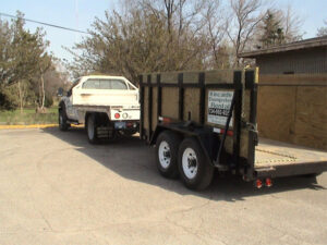 A truck pulling a trailer with a car on it.