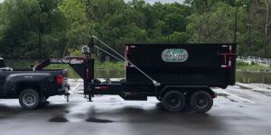 A black trailer with trees in the background