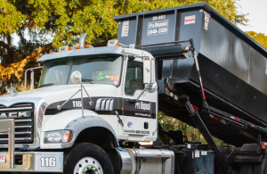 A dump truck is parked on the side of the road.