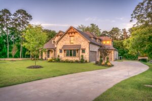 A large brick house with a driveway in front of it.